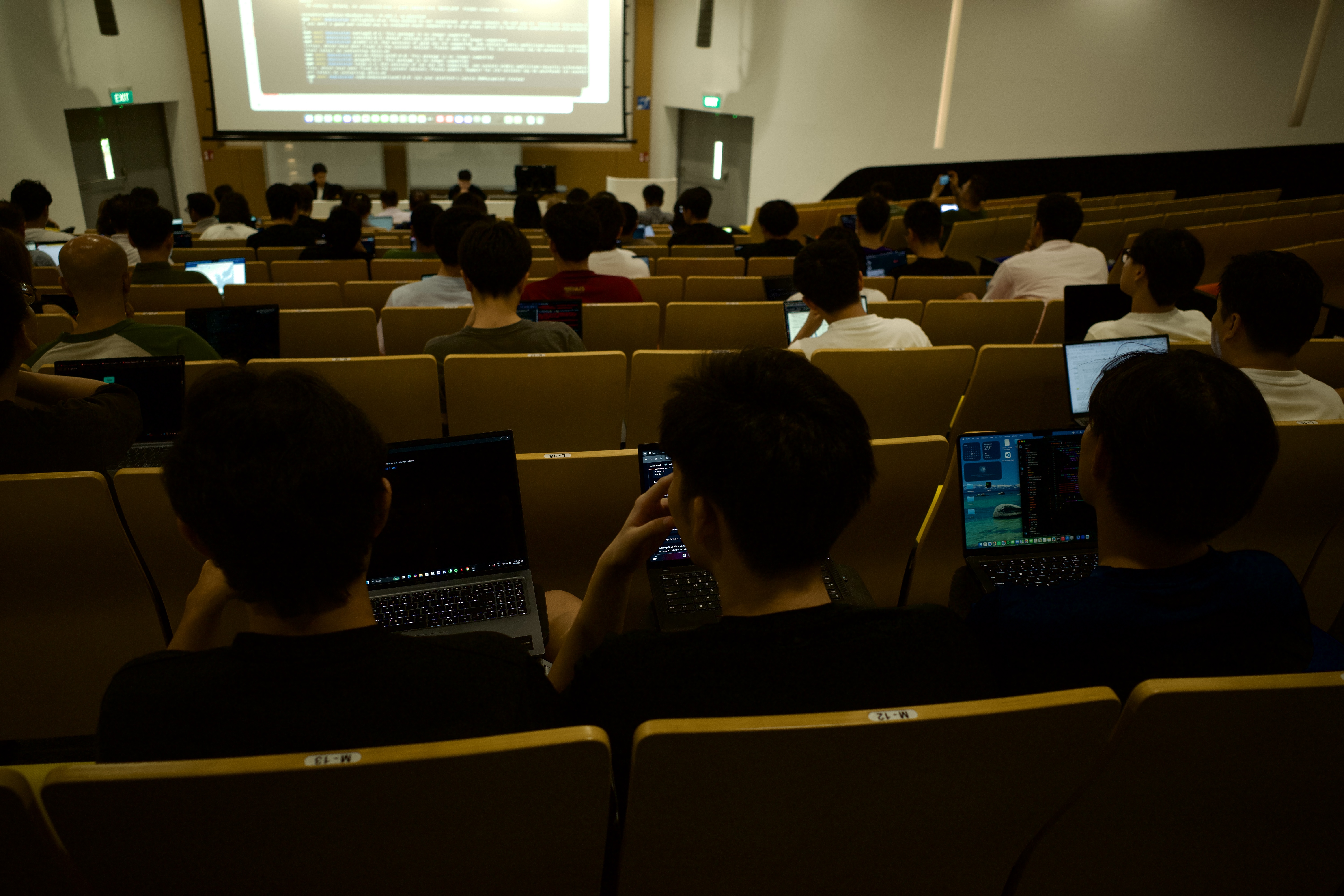 Attendees with laptops open during the live agent build session
